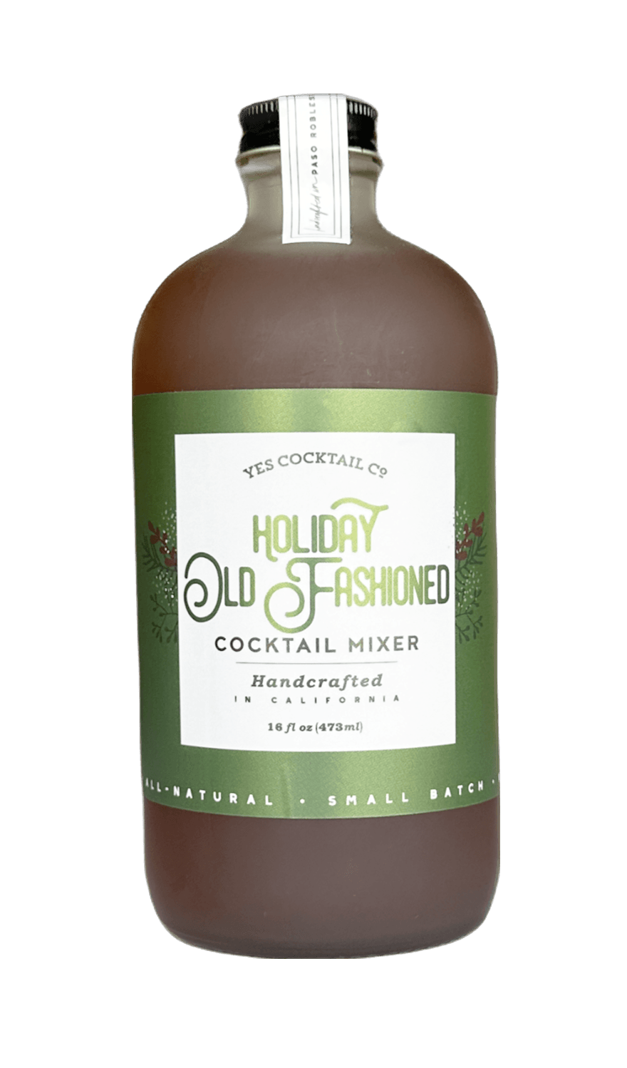 A bottle of Yes Cocktail Co. Holiday Old Fashioned Cocktail Mixer, featuring a brown liquid inside a clear glass bottle with a green and white label, set against a plain white background.