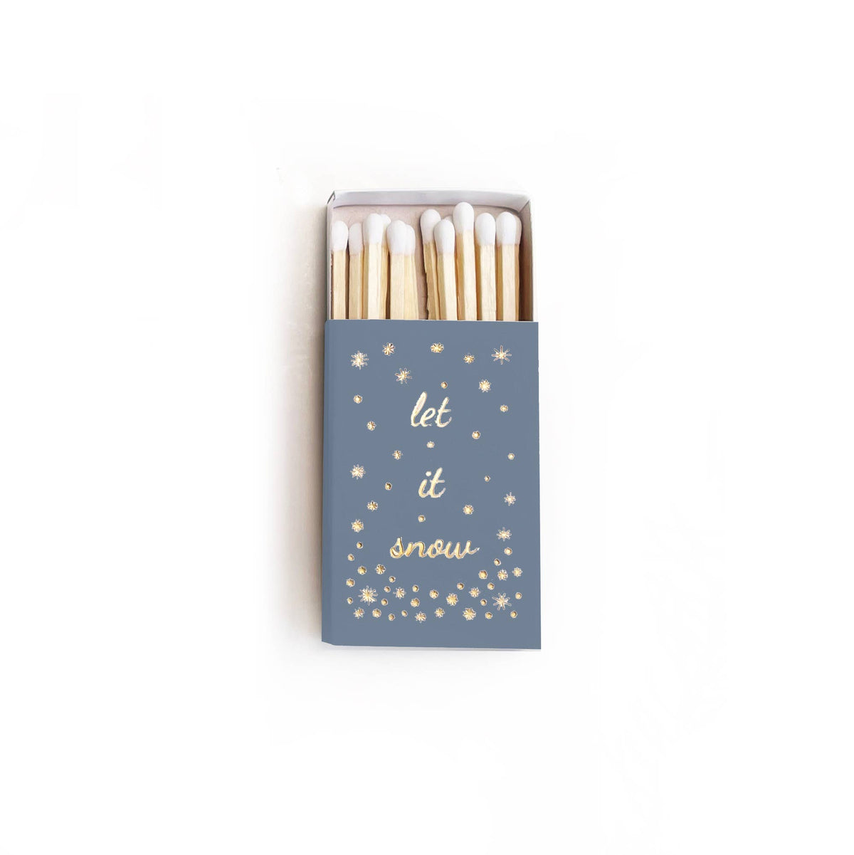 A matchbox of wooden matches with a slate blue cover printed with the phrase 'let it snow' in white script and gold starburst accents, shown on a plain white background.