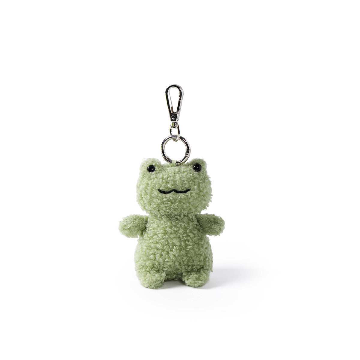 A small plush frog keychain in a light sage green color, featuring a textured fuzzy fabric body, embroidered black eyes and mouth, and a silver metal clasp at the top, shown on a clean white background.