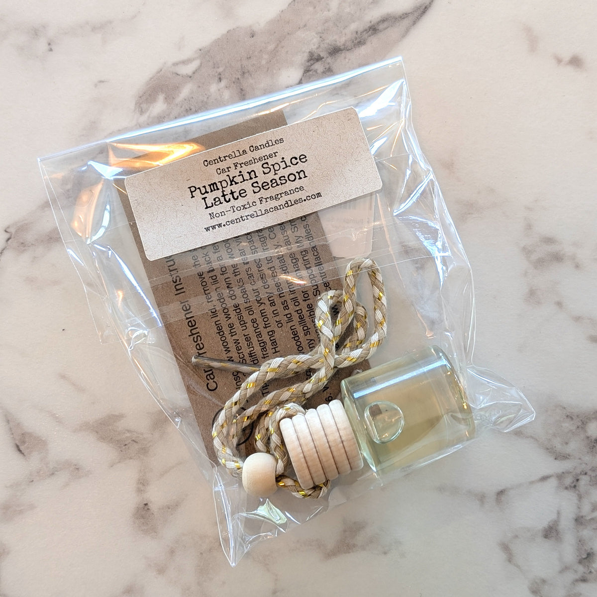 Pumpkin Spice Latte Air Freshener inside a plastic sleeve with a card isnide with description