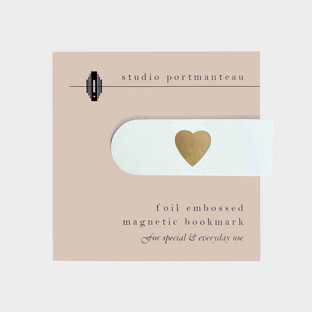 Foil embossed magnetic bookmark with heart design on a beige card by Studio Portmanteau.