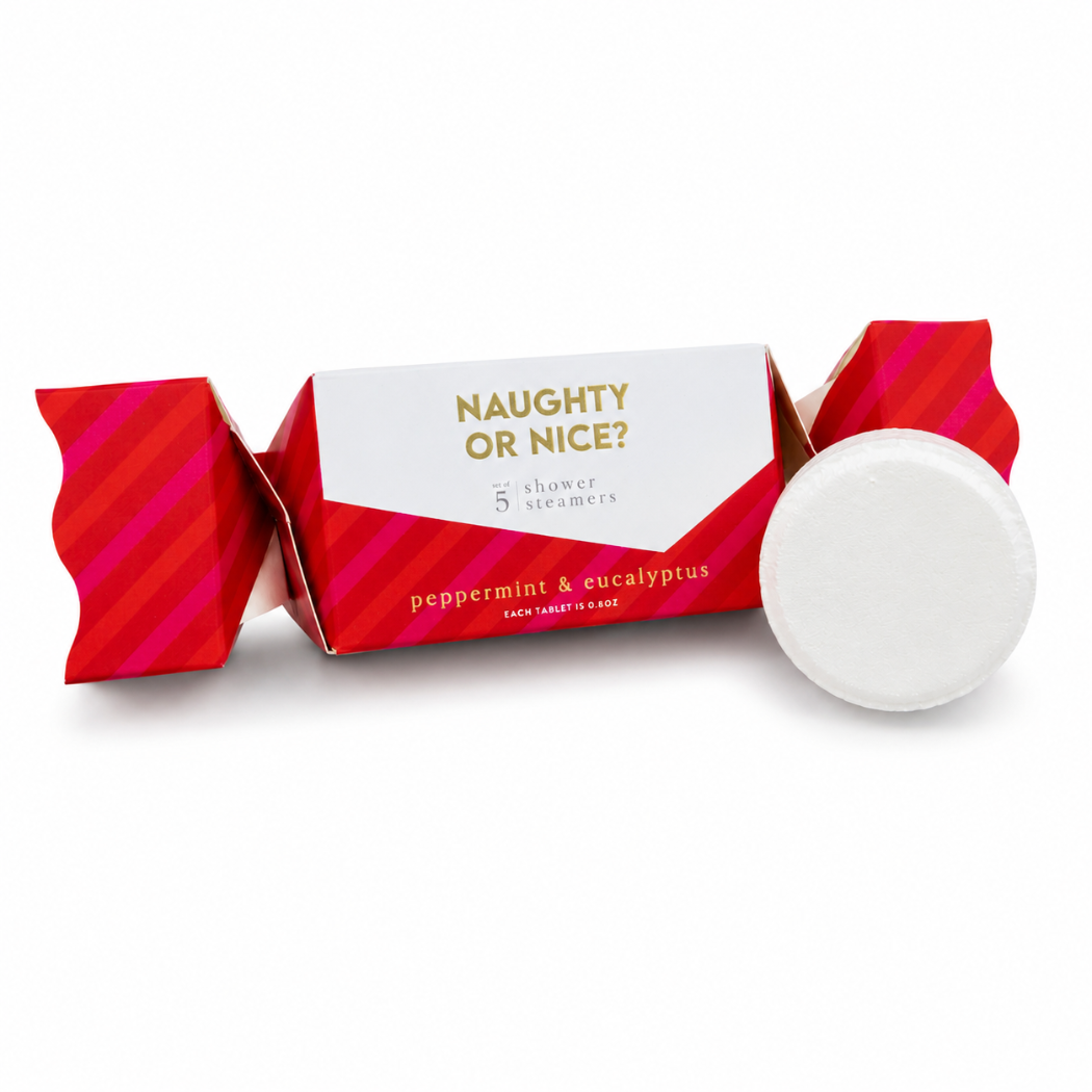 A peppermint and eucalyptus holiday shower steamers shaped like a red and white paper cracker with the text 'NAUGHTY OR NICE?' and 'peppermint & eucalyptus', shown with a single round white peppermint candy on a white background.